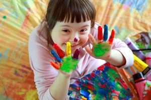 Little girl fingerpainting and making a mess